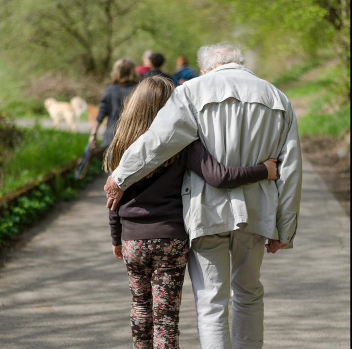 Old man & granddaughter walking